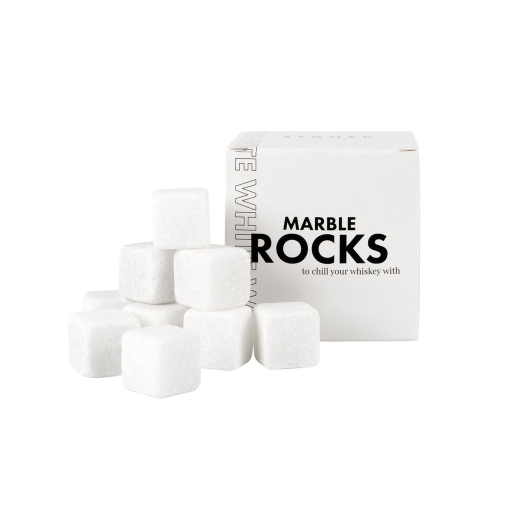 9 white marble whiskey rocks next to box