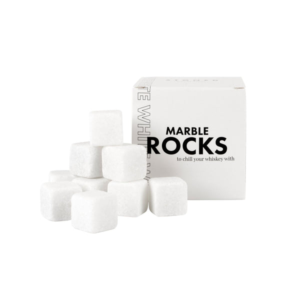 9 white marble whiskey rocks next to box